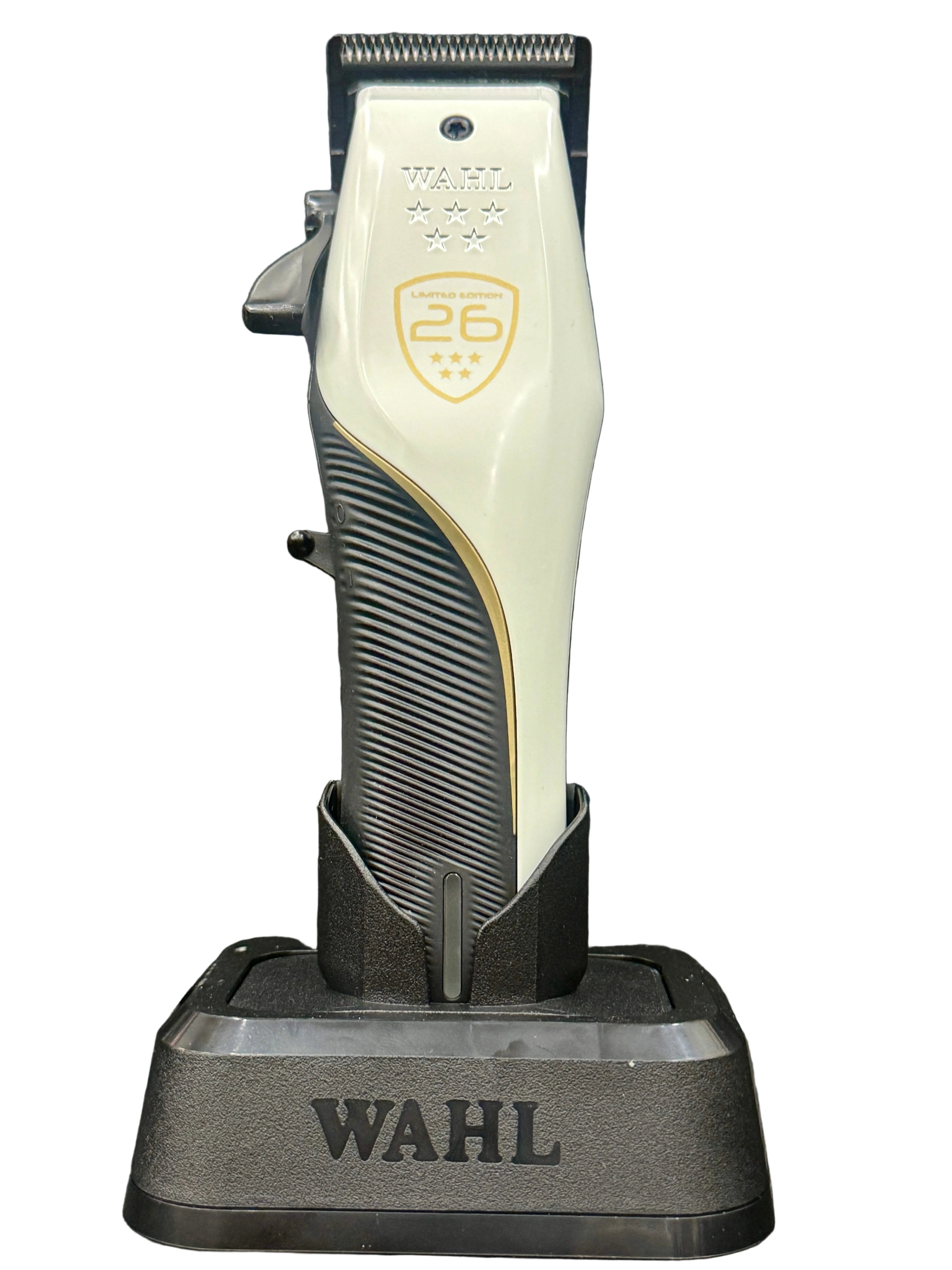Wahl hair trimmer on a black stand against a dark background