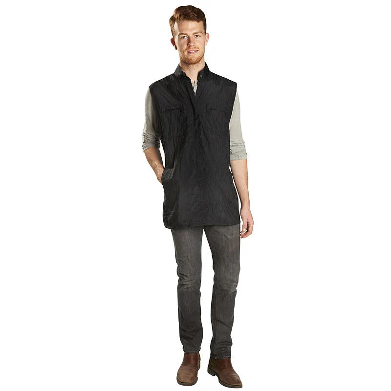 Man wearing a black vest over a gray shirt on a white background