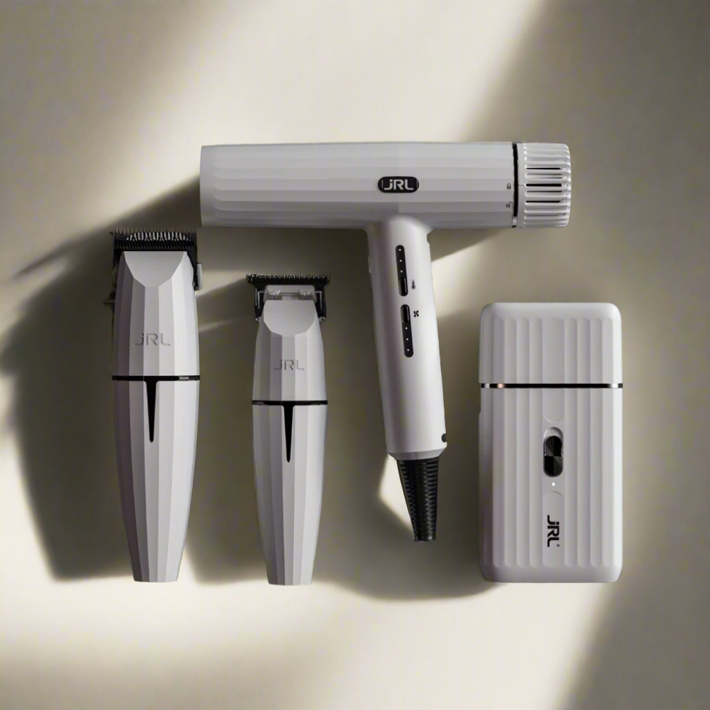 A stunning display of the JRL Ghost Collection, featuring sleek, modern grooming tools with a ghostly, translucent design. The collection includes cordless clippers, trimmers, and accessories, all in a minimalist white and silver color palette with smooth, ergonomic shapes. The equipment rests on a matte black background, highlighting their futuristic appearance. A soft glow effect surrounds the products, emphasizing the 'ghost' theme and creating a sophisticated, cutting-edge aesthetic."

This version emph